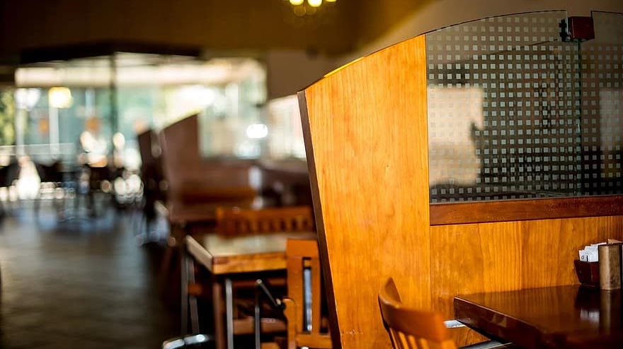Upholstered booth back with a wooden surround